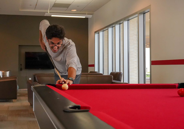 student playing billiards