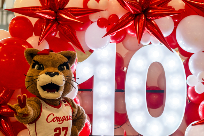 Sasha in front of a "10" sign.