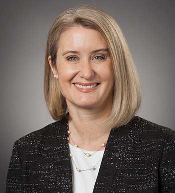 Portrait of a blonde woman smiling.