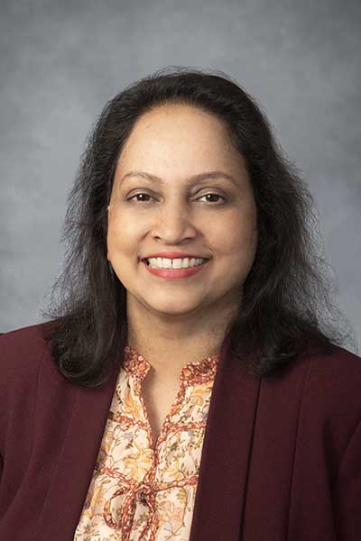 Portrait of an Indian woman wearing a business jacket and blouse. 