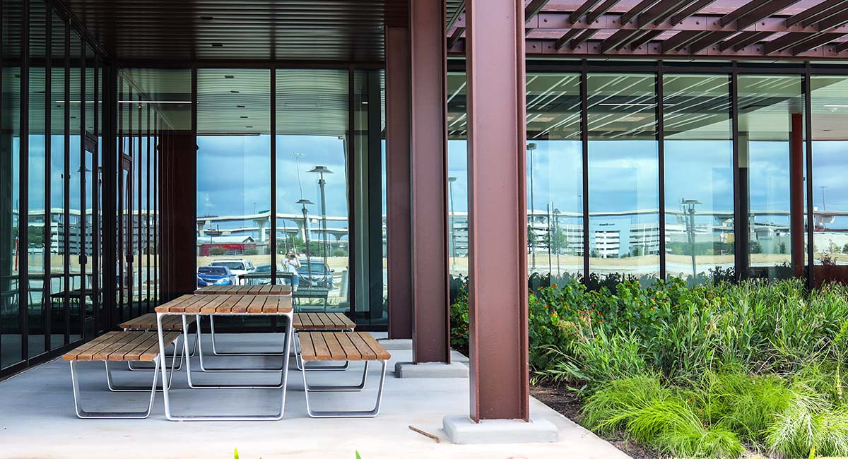 An exterior patio area with a picnic table and garden.