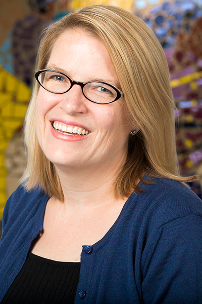 Profile photo of Sarah Narendorf in front of the social work building mural.