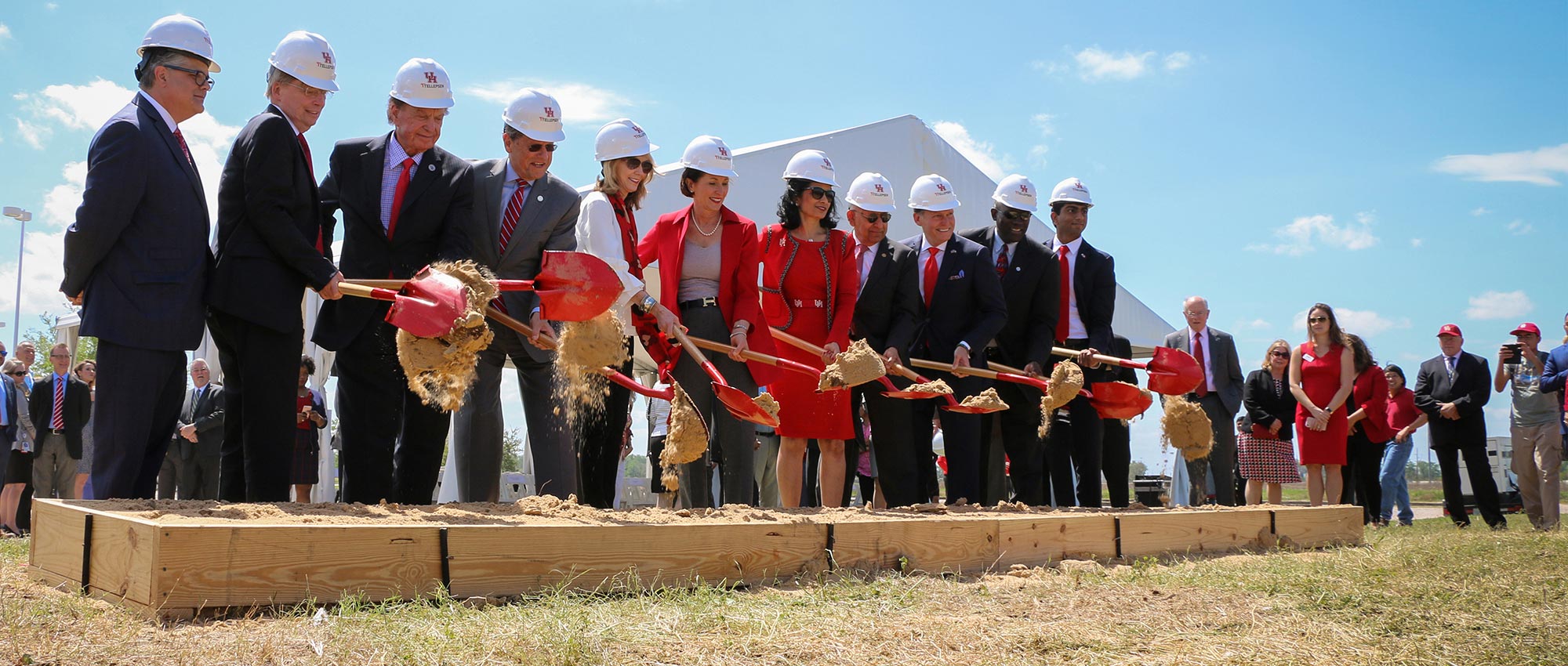 Group of people with shovels at a groundbreaking ceremony