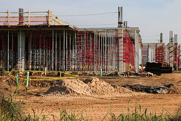 Scaffolding around concrete pillars at a construction site