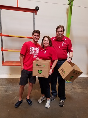 A student with two faculty in a warehouse