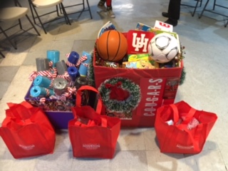 Bags and boxes of gifts on the floor of a room