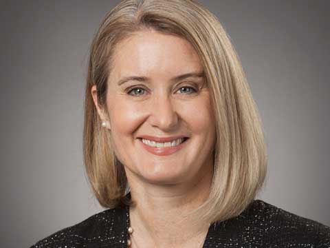 Portrait of a blonde woman smiling.