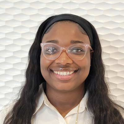 Portrait of a Black woman with glasses.