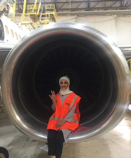 Rawan sitting on an airplane turbofan